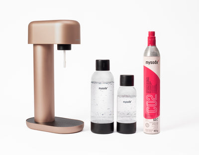 A copper Ruby sparkling water maker with bottle and co2 cylinder