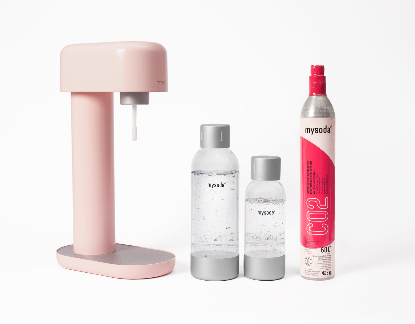 A pink Ruby sparkling water maker with bottle and co2 cylinder