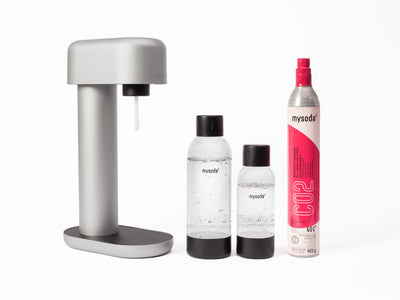 A silver Ruby sparkling water maker with bottle and co2 cylinder
