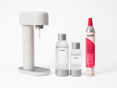 A white Ruby sparkling water maker with bottle and co2 cylinder